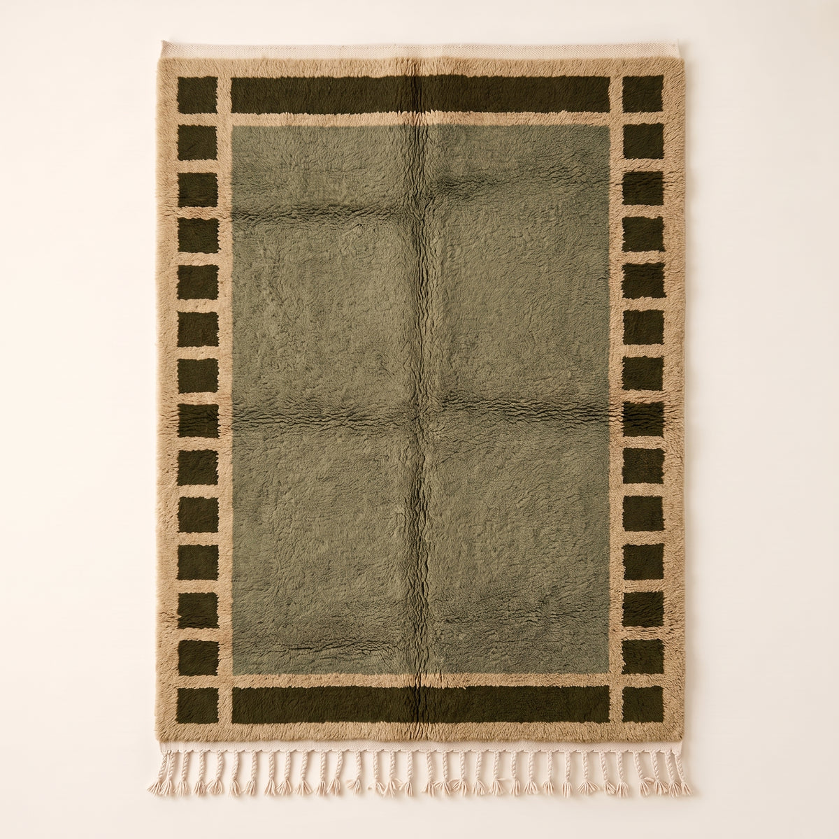 Olive and ivory Mrirt rug with checkered border frame design on plain background