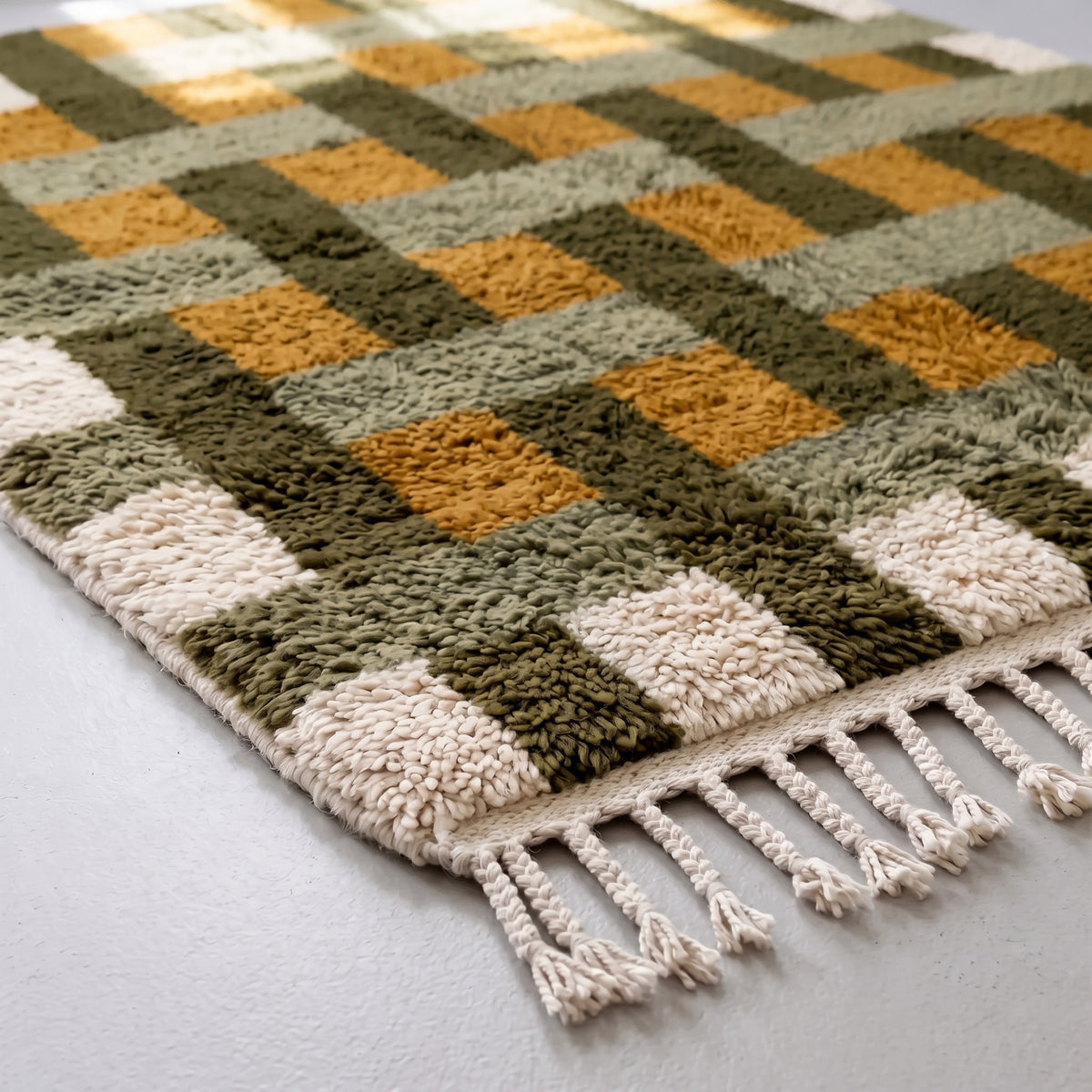Corner detail of Zarwa rug showing fringe and dense knotted construction