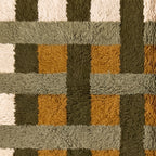 Detailed view of grid weave intersections in olive, mustard and ivory tones
