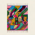 Full view of the Iderfan Boujaad rug in pink, mustard, teal, green and burgundy with jagged abstract patchwork forms
