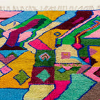 Pattern close-up of Iderfan showing jagged pink, mustard, teal and green color blocks with small geometric marks