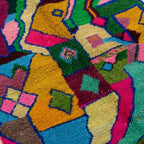 Close-up of the Iderfan Boujaad rug showing plush hand-knotted wool and layered multicolor abstract shapes