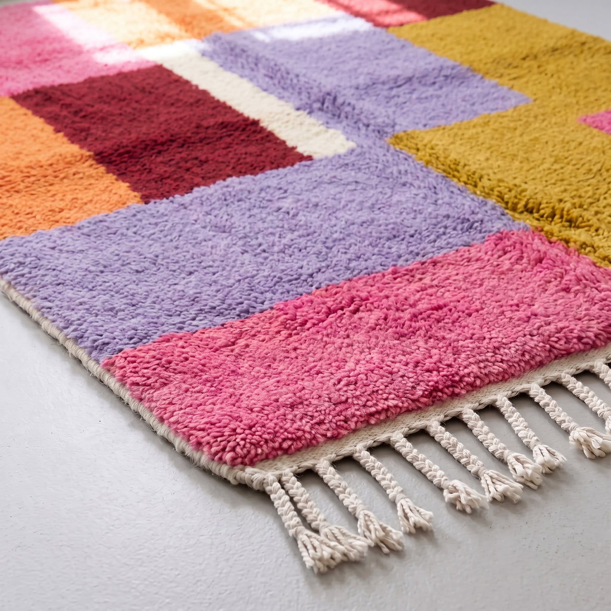 Detail of Zayna Azilal rug fringe and edge, natural cream wool fringe with hand-knotted border