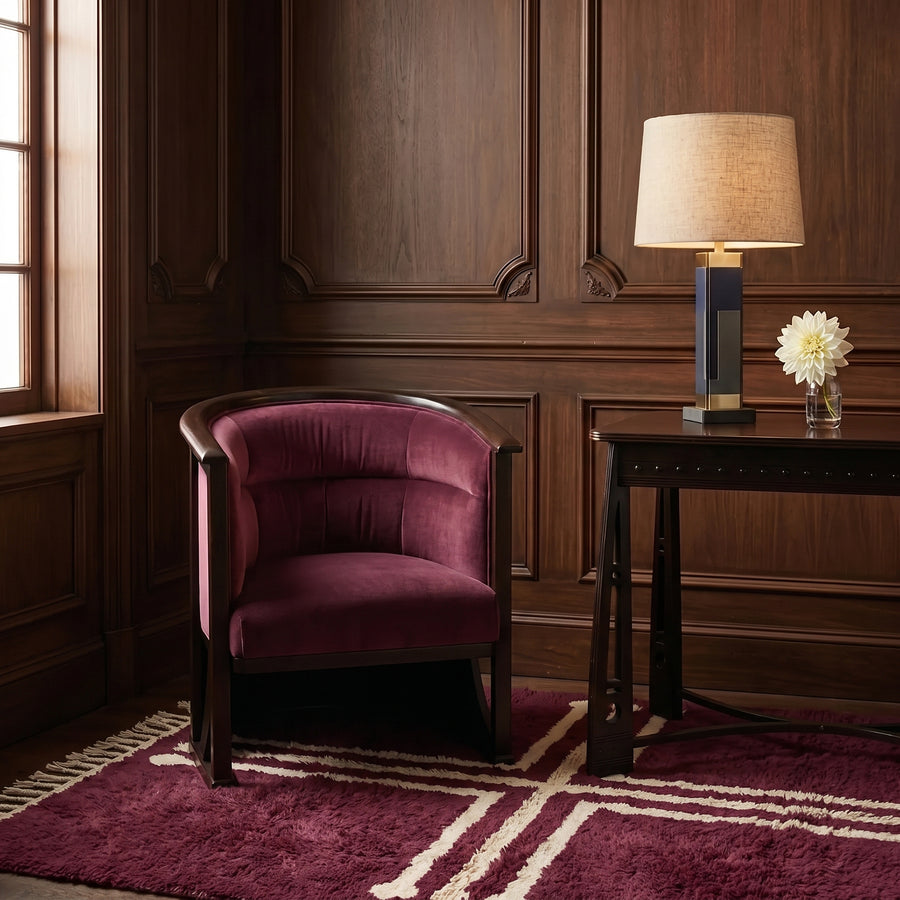 Plum and ivory Beni Ourain cross rug in situ in elegant living room with burgundy chair and wooden panelling