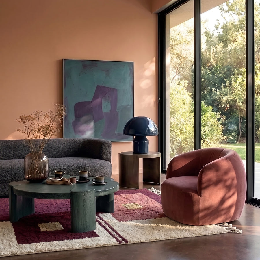 Tafrara plum Mrirt rug in modern living room with burgundy chair, grey sofa and green table