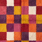 Edge view of Boujaad rug showing colour blocks and cream fringe detail