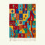 Full view of the Tazdayt red, turquoise and saffron Boujaad rug with a geometric star and diamond patchwork.