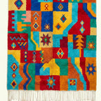 Full view of the Tazdayt Boujaad rug showing its red, turquoise and saffron palette.