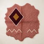 Rose, burgundy and gold Beni Ourain rug with central diamond medallion and cream zigzag border, irregular wavy edges
