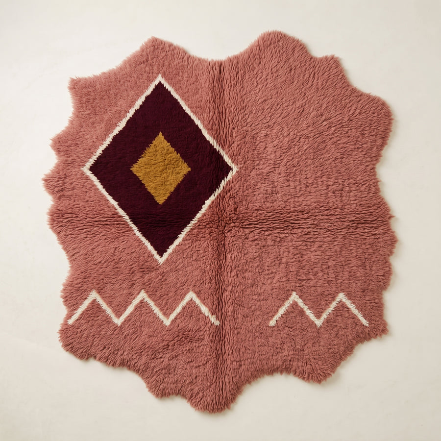 Rose, burgundy and gold Beni Ourain rug with central diamond medallion and cream zigzag border, irregular wavy edges