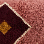 Close-up of the rose medallion pattern on the Lalla Moroccan wool pillow
