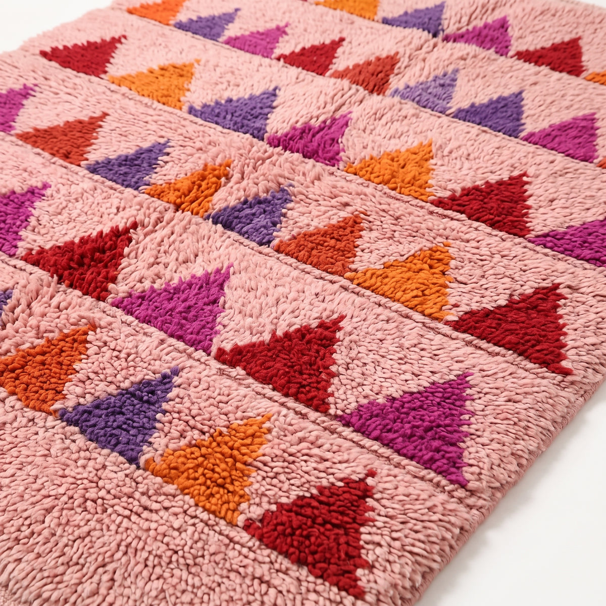 Close-up of handwoven Boujaad sawtooth rows showing dense pile texture and triangle motif detail