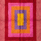 Overhead view of Menna rug showing complete nested rectangle composition with cream fringe at edge and pile depth