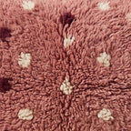 Close-up of the rose speckle pattern on the Tamazight Moroccan wool pillow