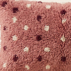 Side view of the Tamazight Moroccan pillow showing its rose and plum wool pile