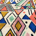 Natural wool texture detail of the ivory coral Tayri Azilal rug