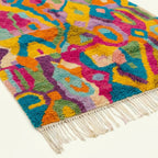 Angled view showing the pattern and wool pile of the Asirem Boujaad rug.