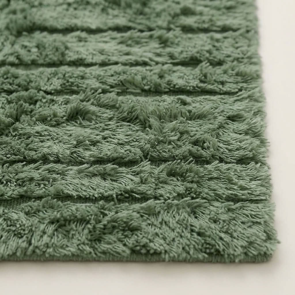 Side angle of Tawenza rug showing depth and softness of sage green handwoven pile