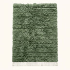 Sage green Beni Ourain rug with cream horizontal bands and thick wool pile, flat lay on white background