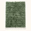 Sage green Beni Ourain rug with cream horizontal bands and thick wool pile, flat lay on white background