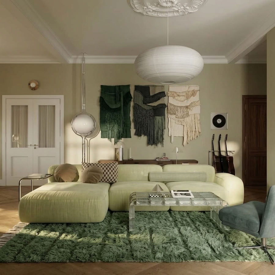 Sage green textured Beni Ourain rug in modern living room with cream sofa and botanical wall hangings