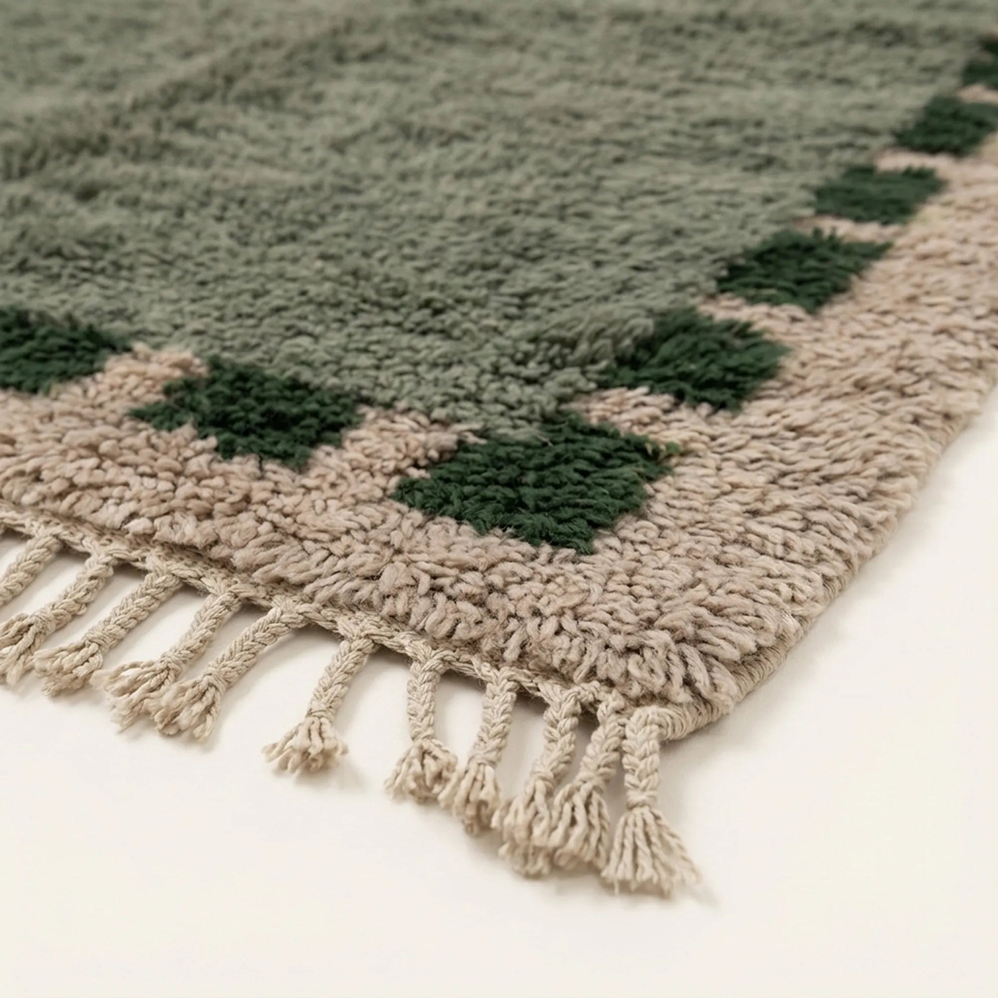 Fringe and edge detail of the Ifru sage green, forest green and ivory Beni Ourain rug.