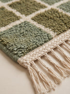 Cream wool fringe and edge detail of the Sage green Mrirt runner showing the twisted tassel trim