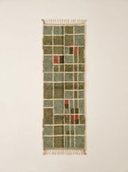 Sage green and olive Mrirt runner with grid check pattern and cream lines, showing accent blocks of pink, mustard and charcoal – Tafat