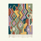 Full view of the Tafrar Boujaad rug in sage, terracotta, lilac and ochre with zigzag diamonds and abstract forms