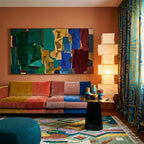 Tafrar Boujaad rug styled in a living room with its sage, terracotta and lilac geometric design visible