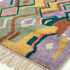 Close-up of the Tafrar Boujaad rug showing plush wool texture in sage, ochre, terracotta and lilac