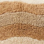 Close-up of the desert stripes pattern on the Tinariwen Moroccan wool pillow