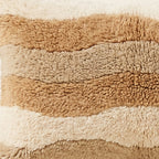 Side view of the Tinariwen Moroccan pillow showing its sand and caramel wool pile