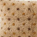 Side view of the Tazwit Moroccan pillow showing its sand and mustard wool pile