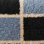 Close-up of the block check pattern on the Tisent Moroccan wool pillow