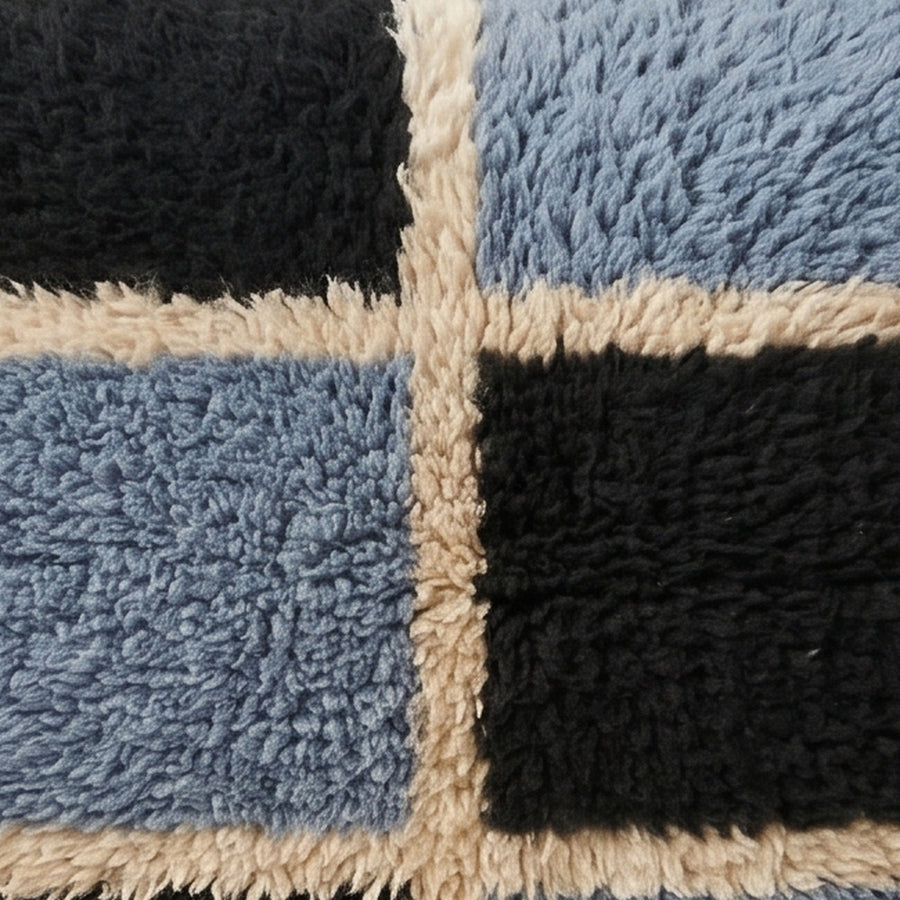 Close-up of the block check pattern on the Tisent Moroccan wool pillow