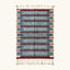 Full view of the Izen slate blue, burgundy and ivory Beni Ourain rug with a horizontal band design.