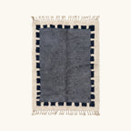 Full view of the Tamesna slate blue, navy and ivory Beni Ourain rug with a block border design.
