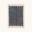 Full view of the Tamesna slate blue, navy and ivory Beni Ourain rug with a block border design.