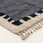 Close-up of the natural Atlas wool pile on the Tamesna slate blue, navy and ivory Beni Ourain rug.