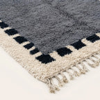 Fringe and edge detail of the Tamesna slate blue, navy and ivory Beni Ourain rug.