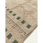 Soft ivory and green wool texture detail of the Tala Moroccan rug.