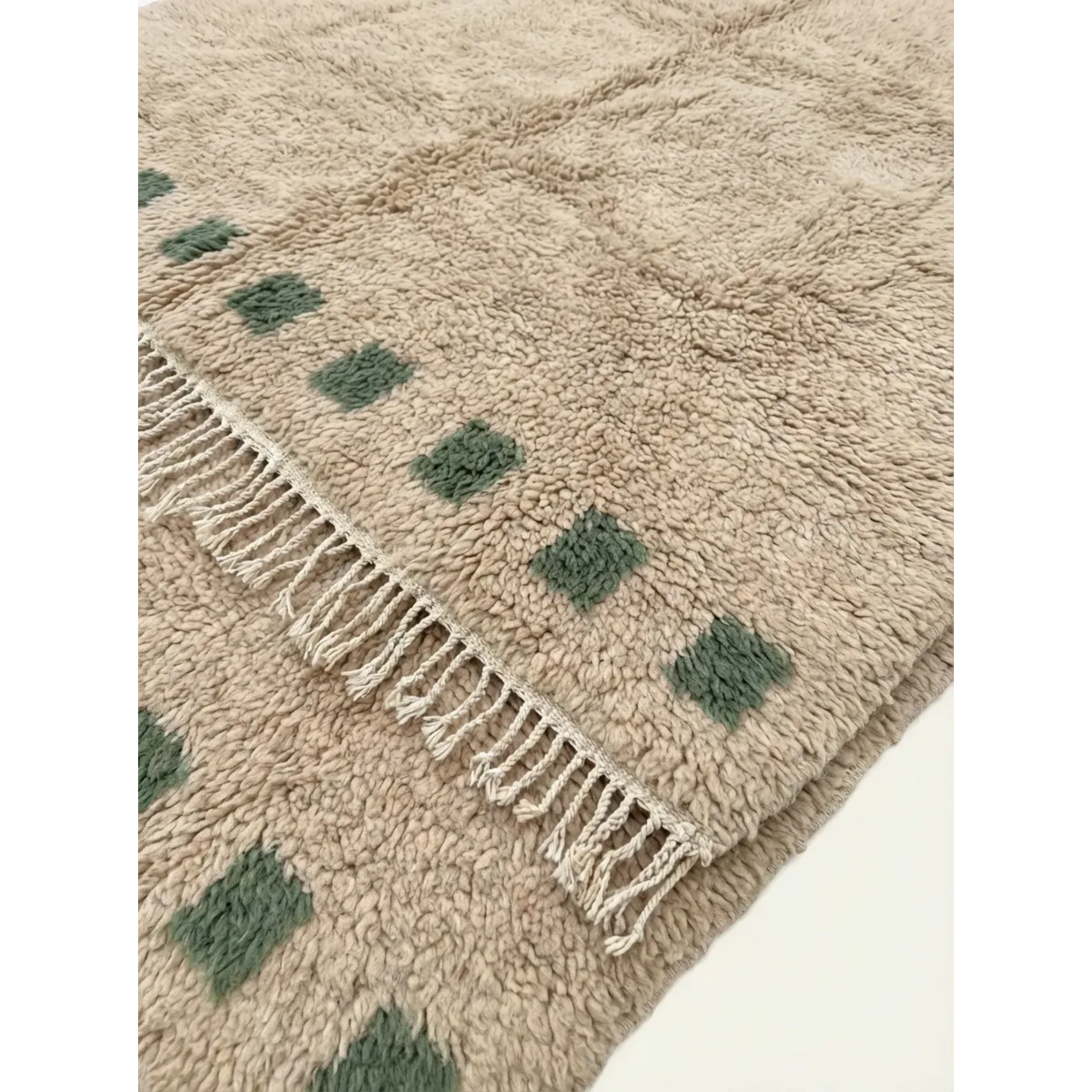 Soft ivory and green wool texture detail of the Tala Moroccan rug.