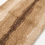 Angled close-up of plush wool pile showing depth and texture of spot pattern