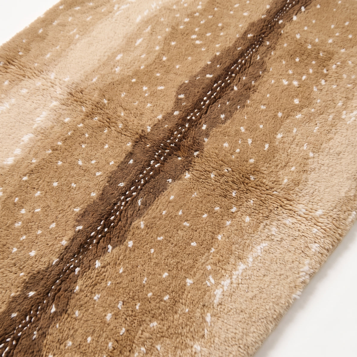 Angled close-up of plush wool pile showing depth and texture of spot pattern