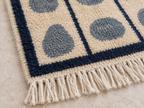 Edge detail showing navy border, cream fringe and finished edge of runner