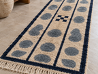 Runner in room setting showing depth perspective of pebble columns and vertical stripe pattern
