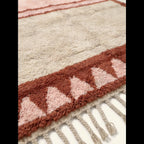 Hand-tied fringe and plush Atlas wool detail of the Tanirt blush rug.