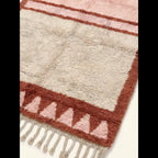 Close-up of the blush and ivory framed triangle motif on the Tanirt rug.