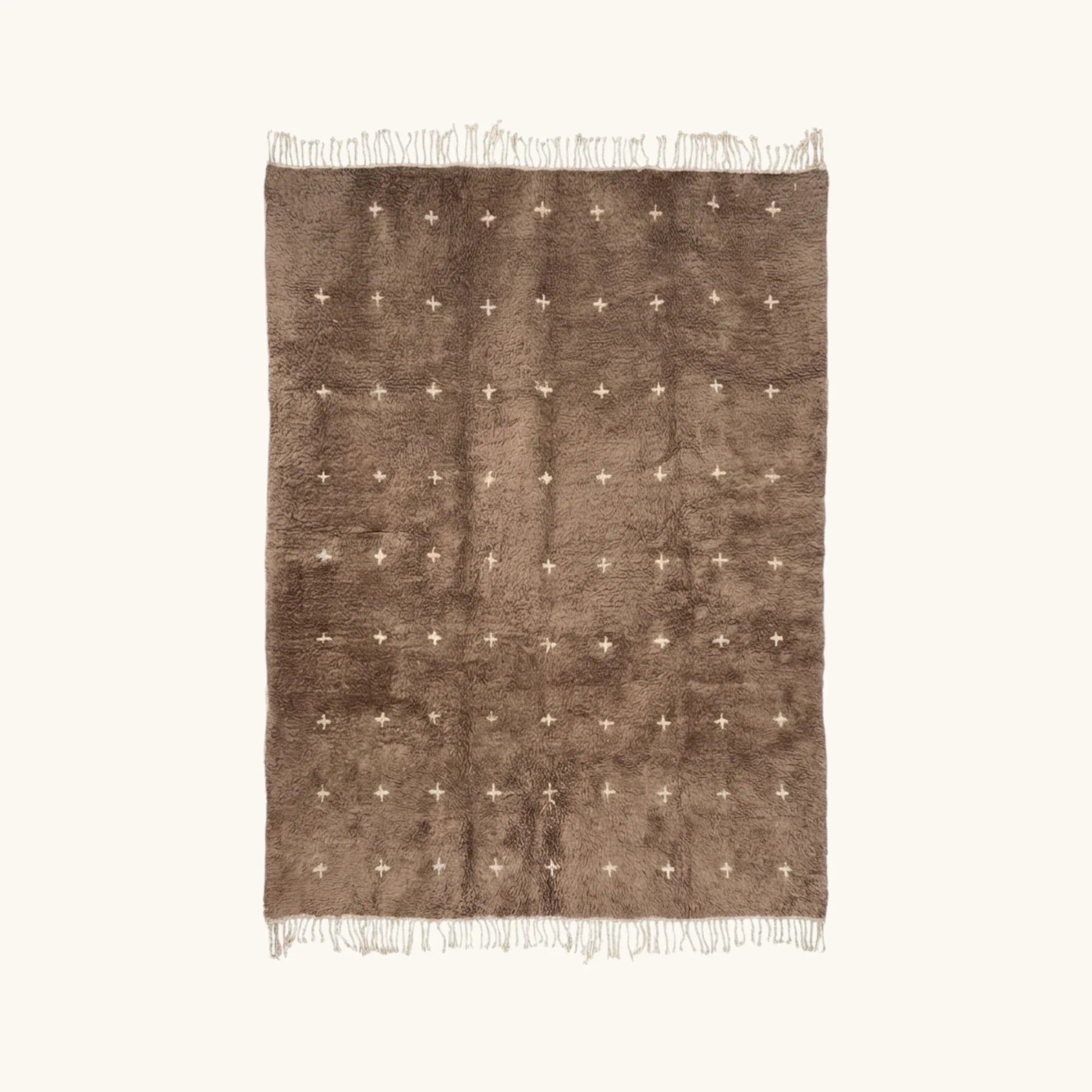 Full view of the Targa taupe Beni Ourain rug with small ivory cross motifs.